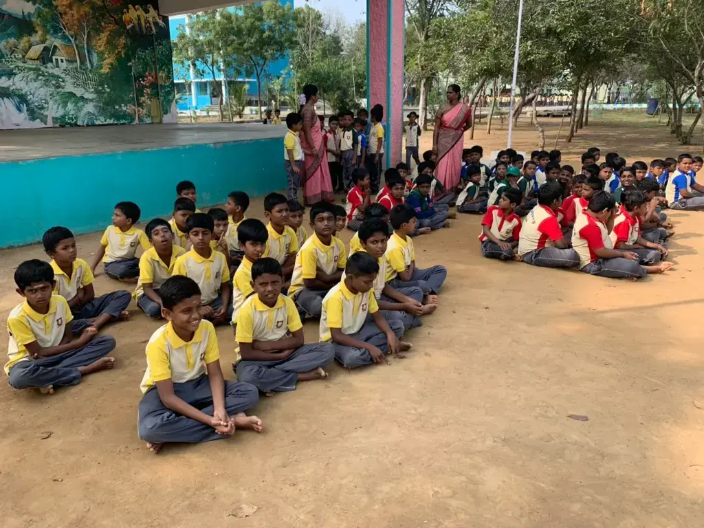 Groups of students sitting in the courtyard of Saint Antony school