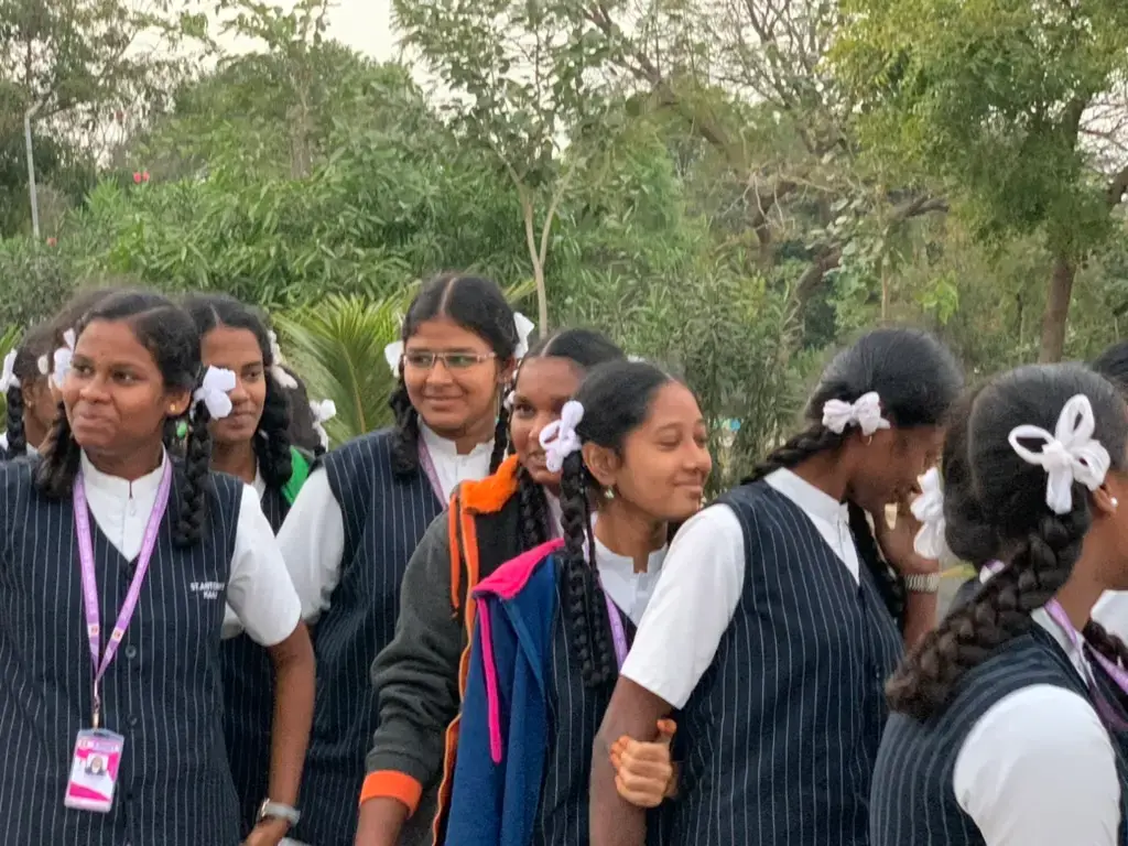 Smiling female students from Saint Antony school gathered together for a group photo