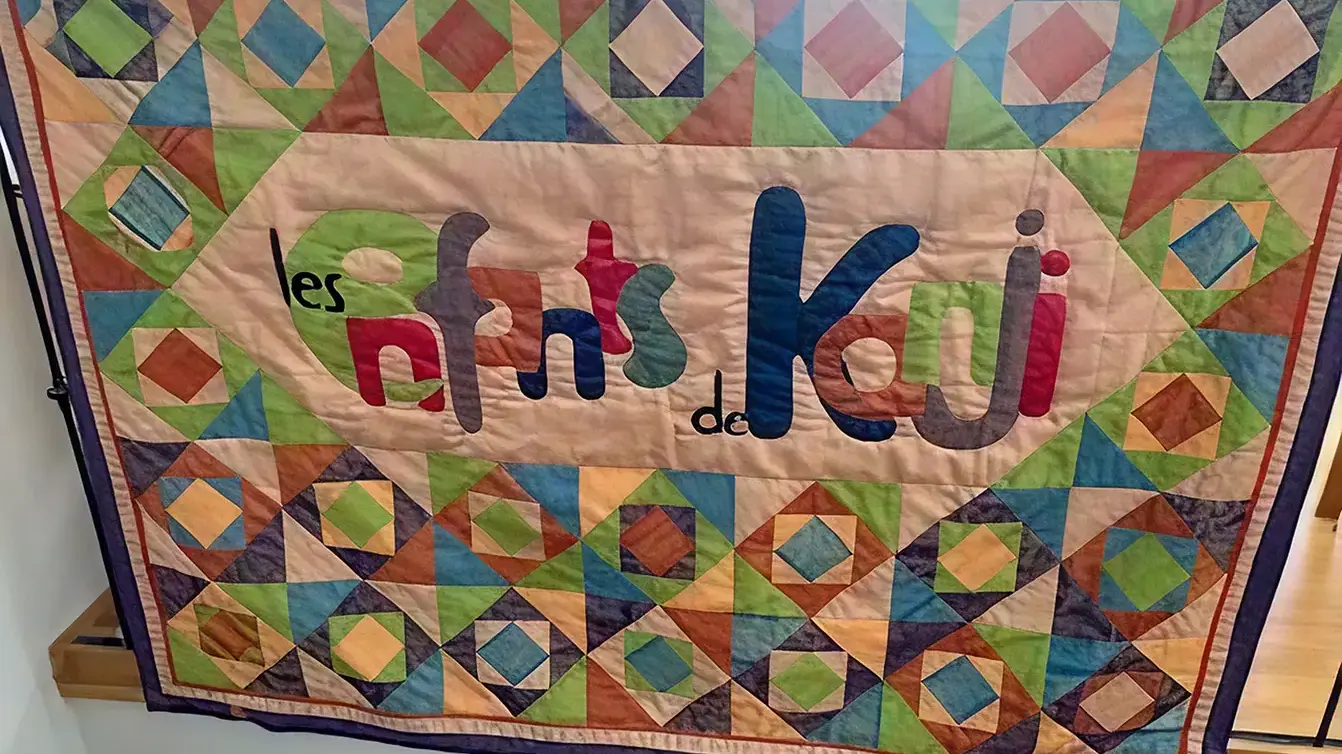 Tapestry with the association's name embroidered on it